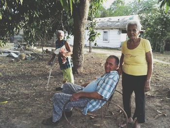 Full length of father and daughter sitting on chair