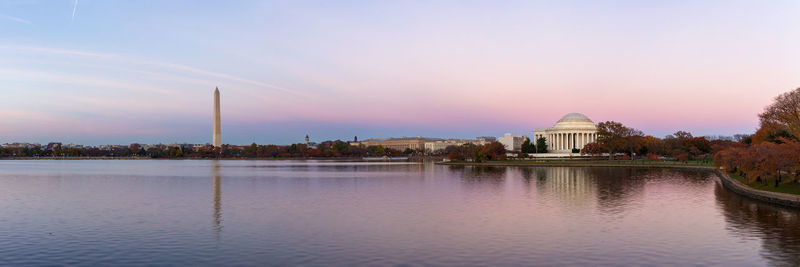Panoramic view of lake and buildings against sky
