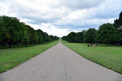 Road amidst trees against sky