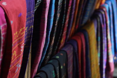 Row of scarves on display at market stall