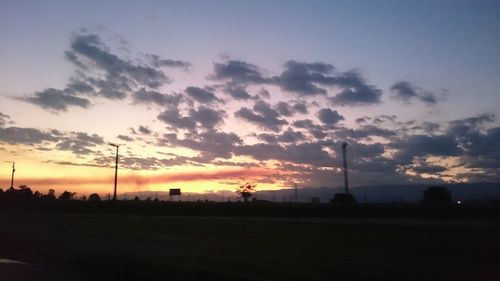 Scenic view of landscape against sky at sunset