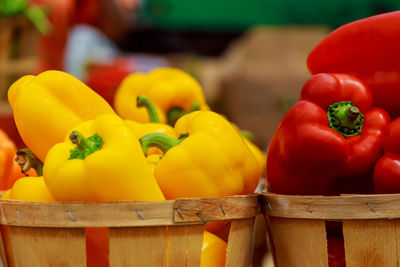 Close-up of bell peppers in containers for sale at market