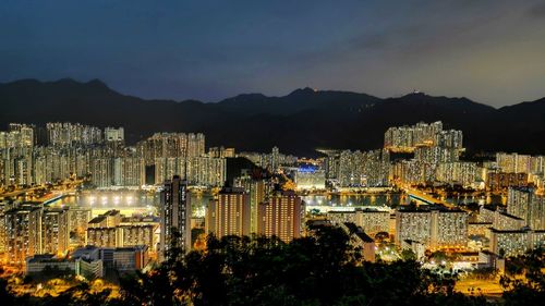 High angle view of illuminated buildings in city at night