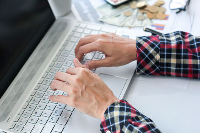 Midsection of man using mobile phone