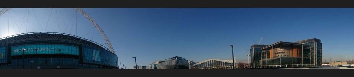 Low angle view of buildings against clear blue sky