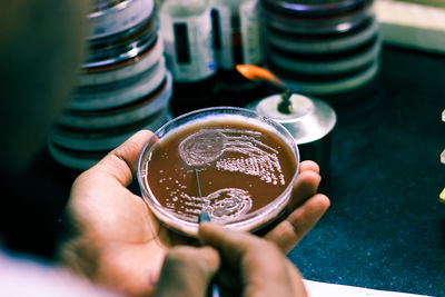 Close-up of hand holding coffee cup