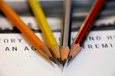 Close-up of sharp pencils on book