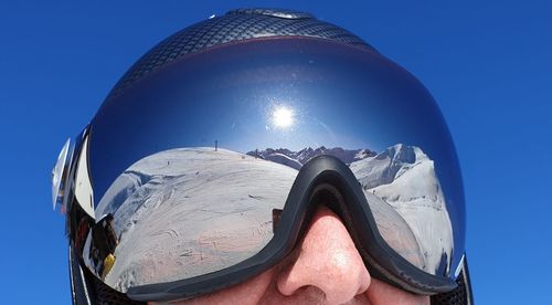 Close-up of person against blue sky