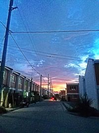 Empty road along buildings