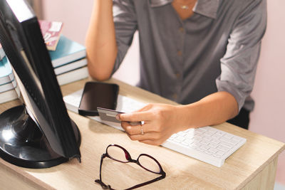 Midsection of businessman working at desk in office