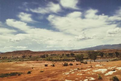 Scenic view of mountains against cloudy sky