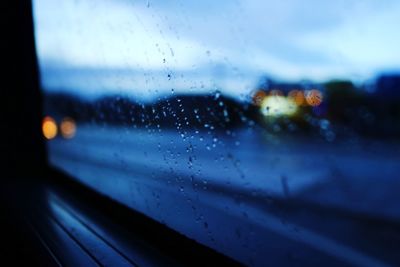 Close-up of wet glass window in rainy season