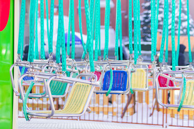 Empty seats of childrens carousel in amusement park