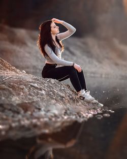 Woman sitting on rock