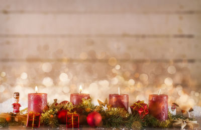 Close-up of illuminated candles on table