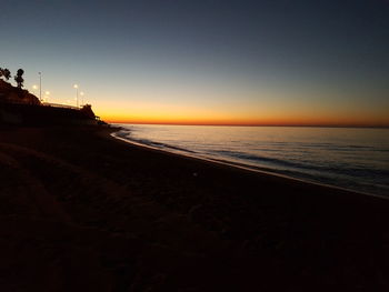 Scenic view of beach at sunset
