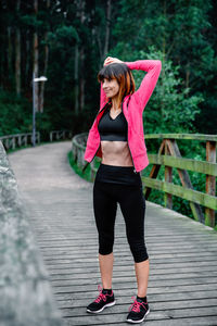 Full length of woman standing on footpath
