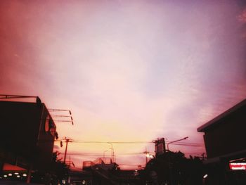 Low angle view of silhouette buildings against sky