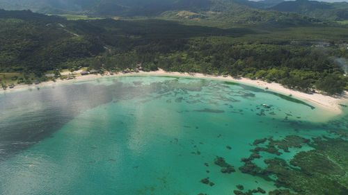 Beautiful tropical beach with turquoise water in blue lagoon, anguib, philippines, santa ana.