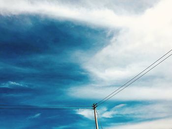 Low angle view of electricity pylon against sky