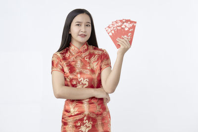 Young woman smiling against white background