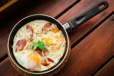 High angle view of fried egg in pan on table