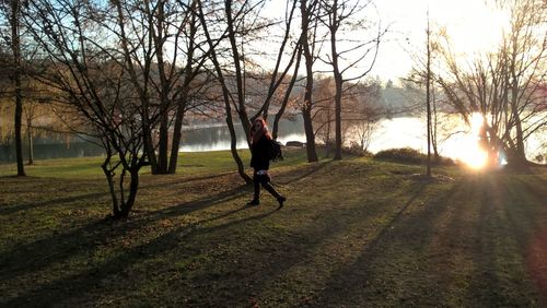 Man walking on bare tree