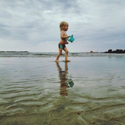 Small boy playing  in the sea.