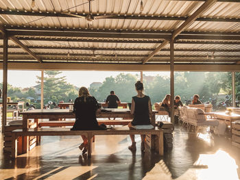 Rear view of people standing on table