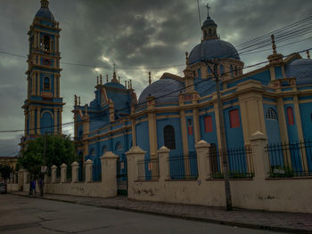 Facade of church against cloudy sky