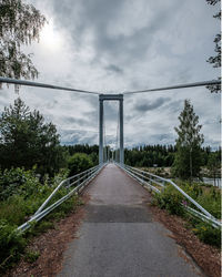 Road by bridge against sky