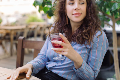 Midsection of woman holding drink