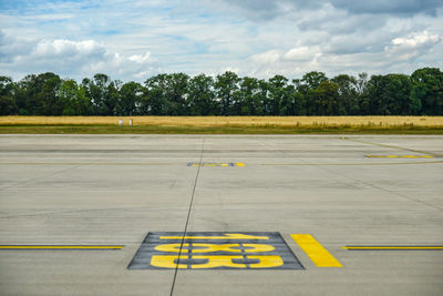 View of inscription on airport runway against sky