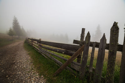 Fence on field against sky