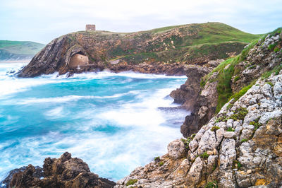 Scenic view of sea and rocks against sky