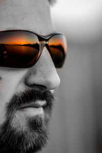 Close-up portrait of young man wearing sunglasses