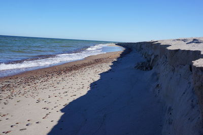 Scenic view of beach against blue sky