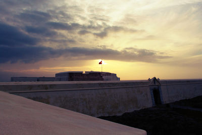 View of sea against cloudy sky at sunset