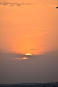 Scenic view of sea against orange sky