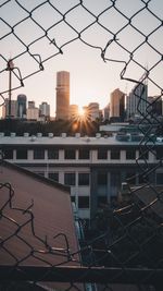 Cityscape against sky during sunset