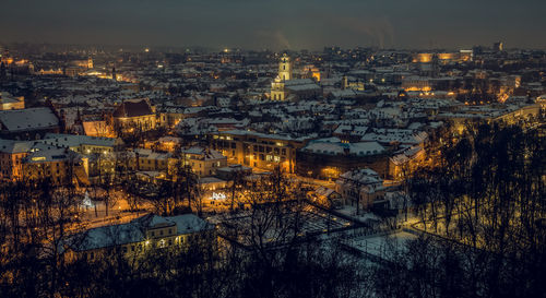 High angle view of illuminated cityscape against sky at dusk