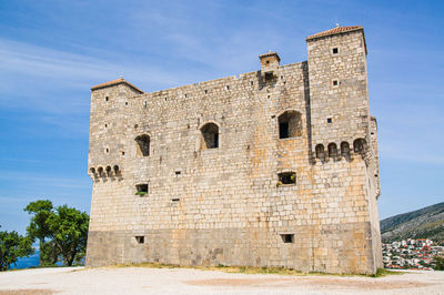 Low angle view of historic building against sky