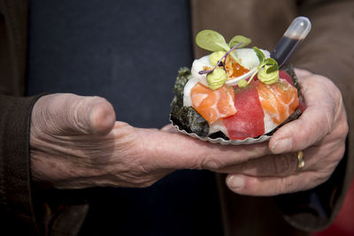 Midsection of man holding food 