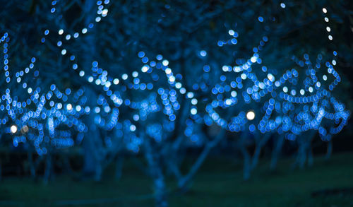 Close-up of illuminated blue water at night