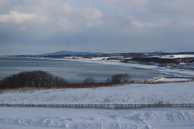 Scenic view of sea against sky during winter