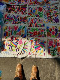 Low section of person standing on multi colored graffiti