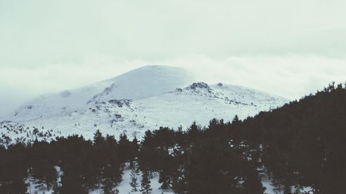 Scenic view of mountain range against cloudy sky