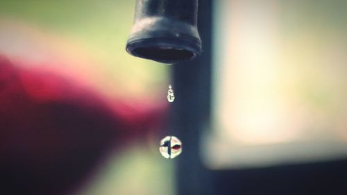 Close-up of water drop on faucet