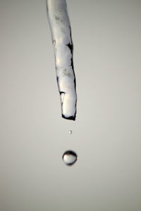 Close-up of water drop against white background