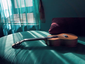 Man playing guitar on table at home